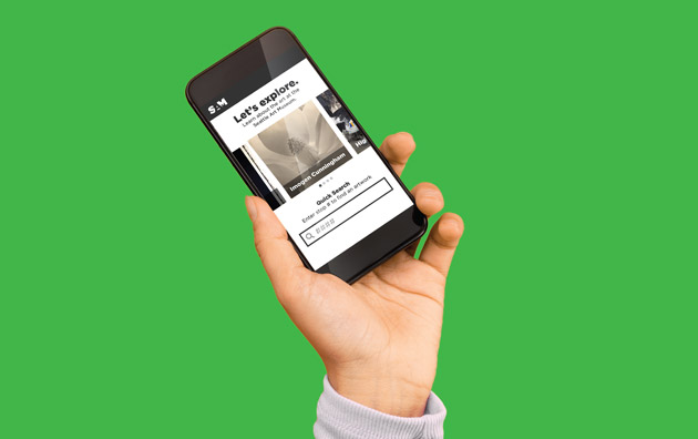 Image of a hand holding a smartphone with the tour experience on screen